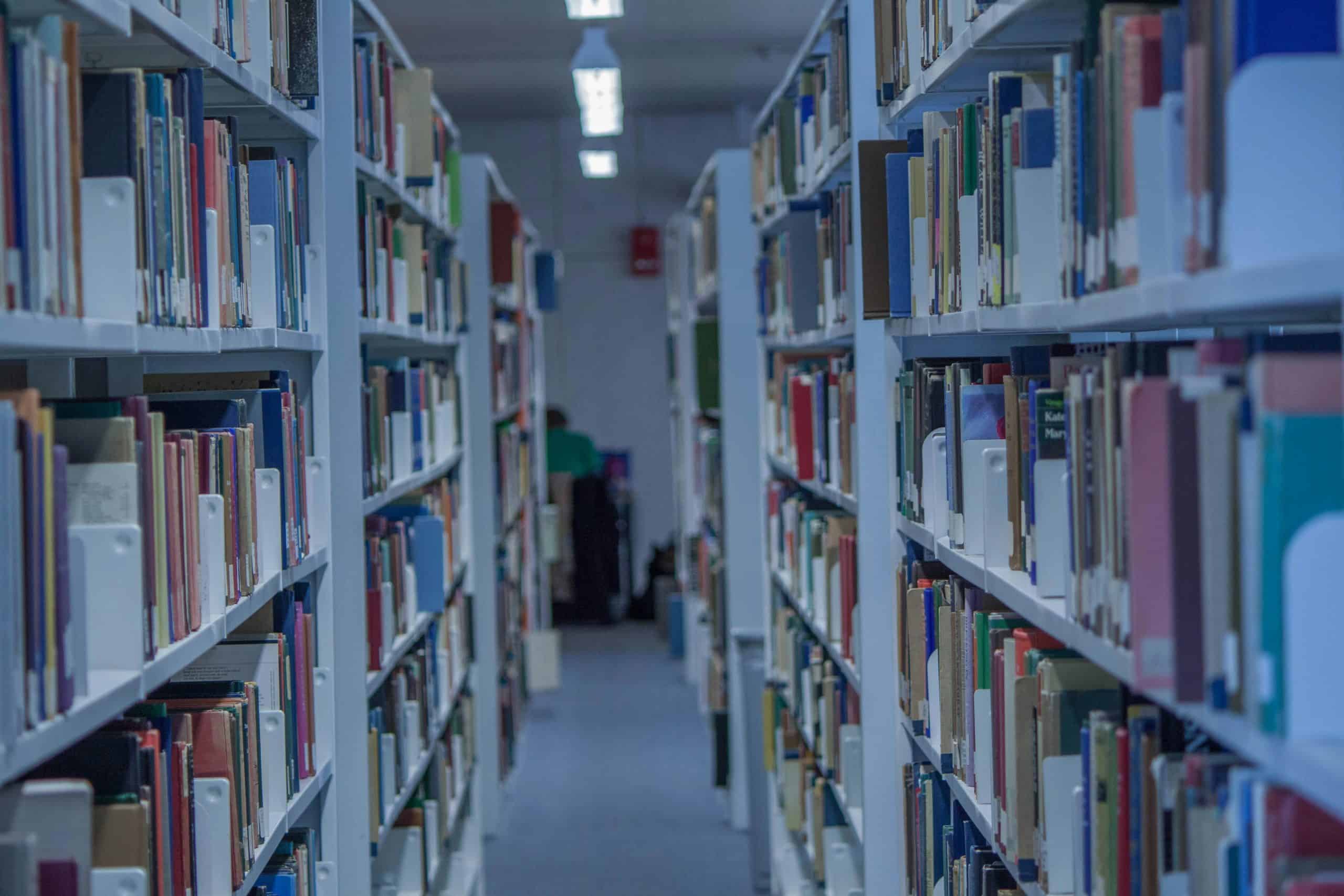 A library aisle filled with books.