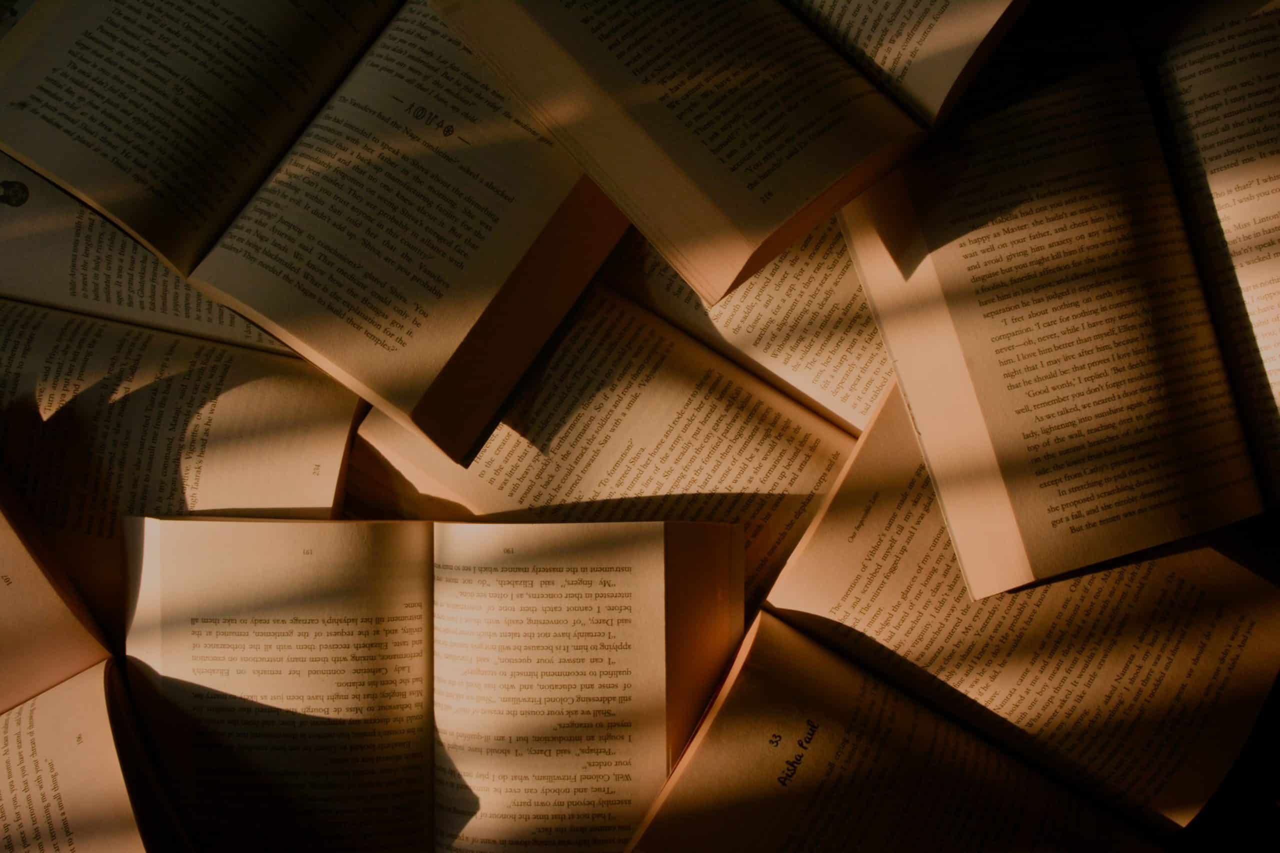 Mystery of Open Books in Darkness Open books scattered in dim light, creating a mysterious atmosphere.